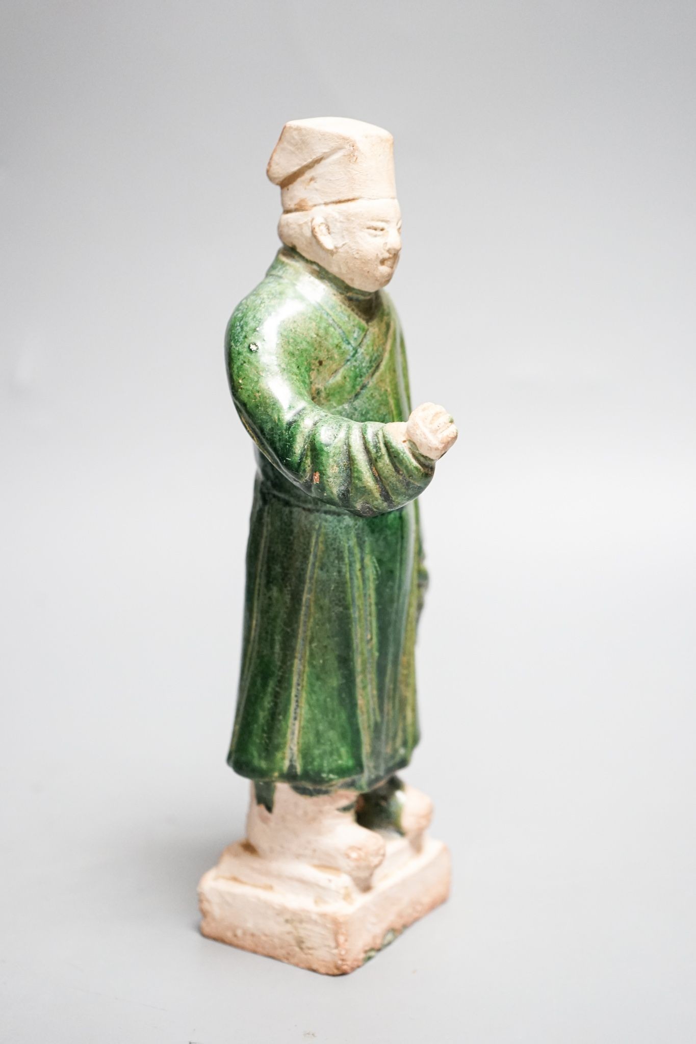 A Chinese Ming green glazed figure of an official 23cm